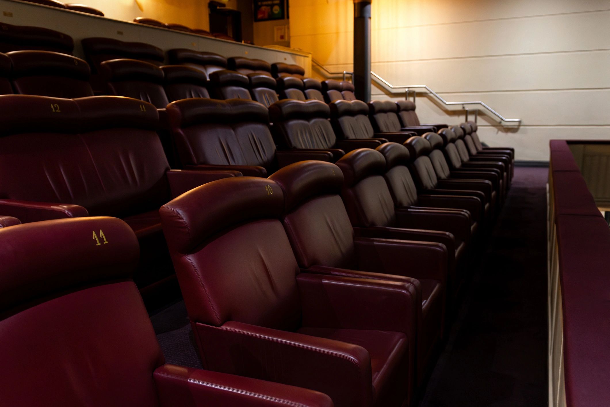 Luxury cinema seating in dramatic lighting